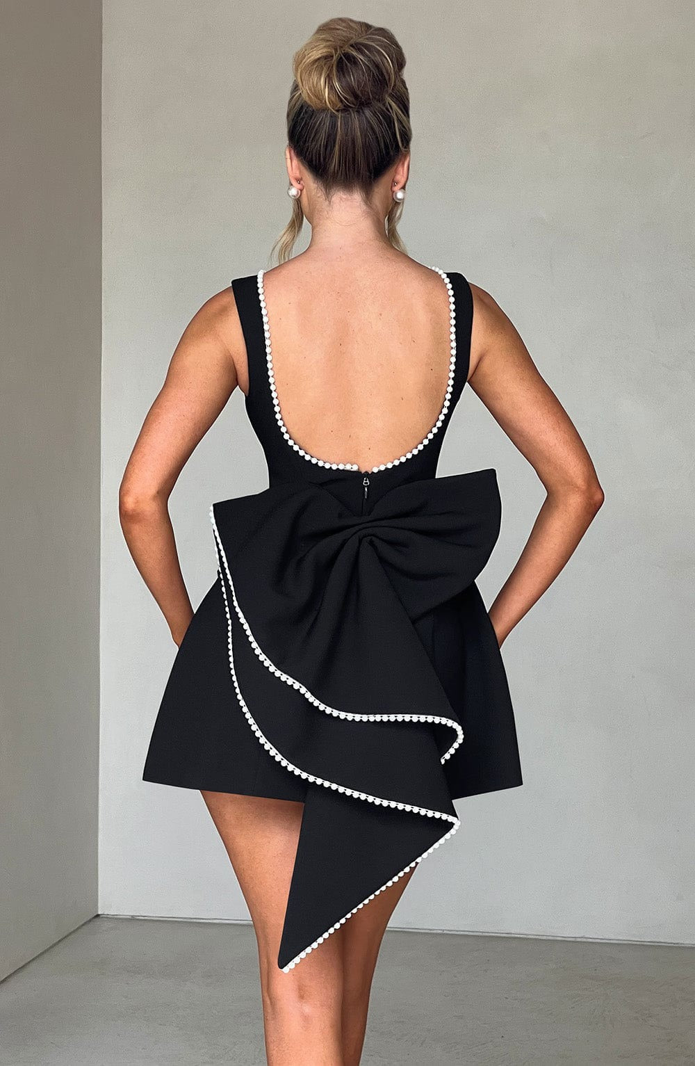 Pearl Trim A-Line Mini Dress Statement Bow Back Sleeveless Flowing Silhouette
