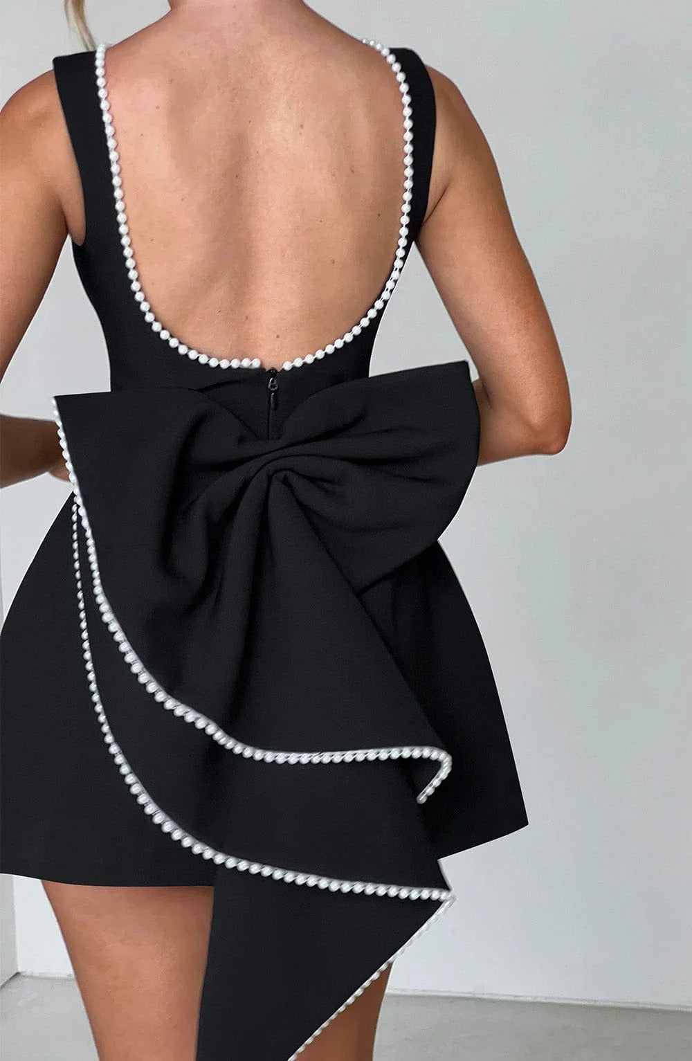 Pearl Trim A-Line Mini Dress Statement Bow Back Sleeveless Flowing Silhouette