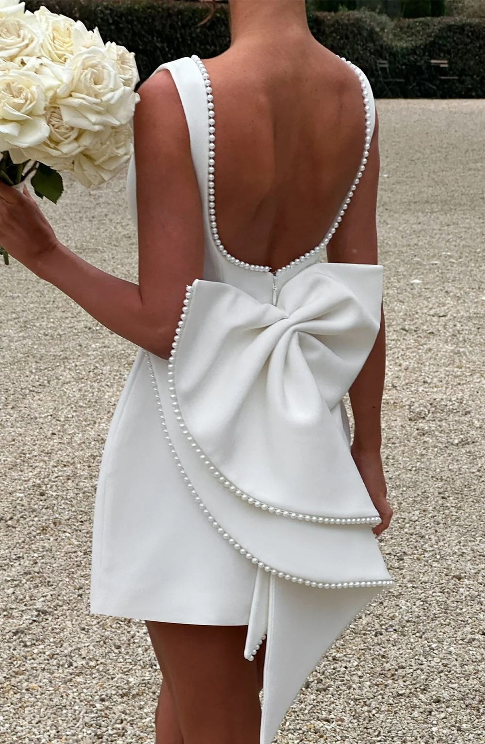 Pearl Trim A-Line Mini Dress Statement Bow Back Sleeveless Flowing Silhouette